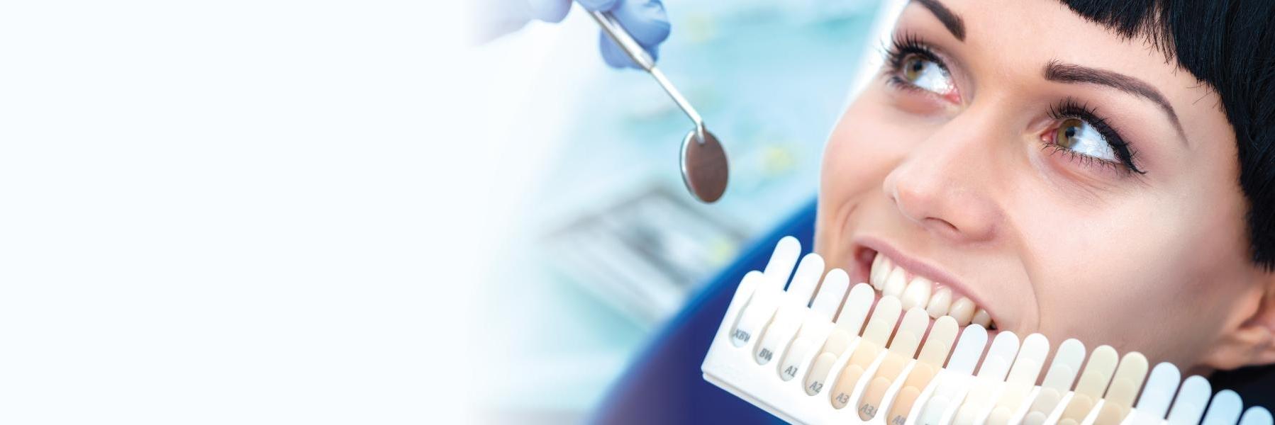 Woman choosing tooth color l Family Dentistry of Royal Oak