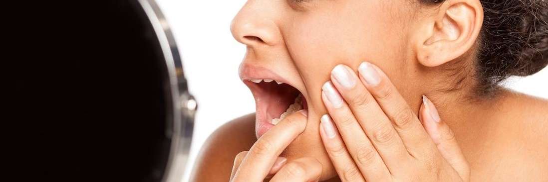 A young woman looking at a dental cavity in Royal Oak, MI
