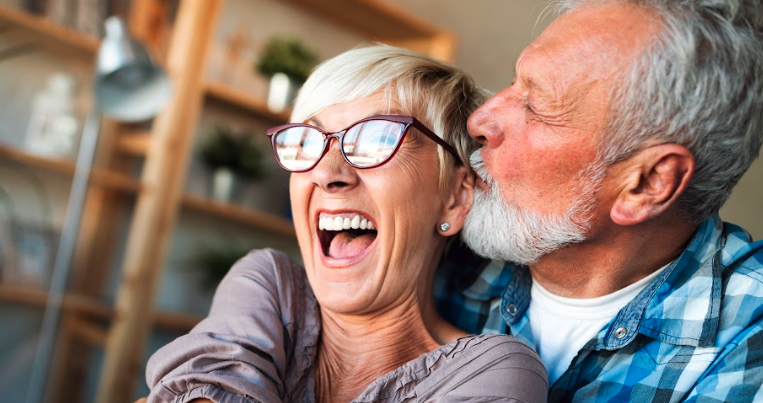 Couple hugging after dental treatment in Royal Oak, MI