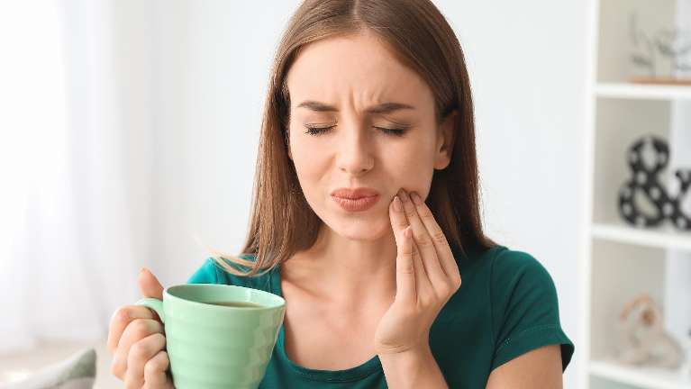 Woman having tooth pain in Royal Oak, MI