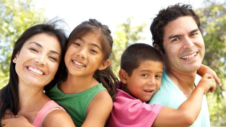 A happy family poses for a photo after dentistry session at Royal Oak Family Dentistry