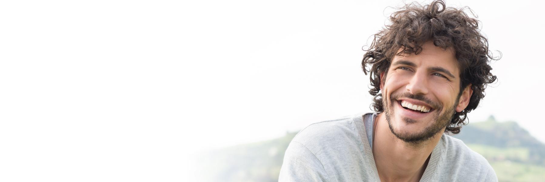 Young man with white smile l Teeth whitening royal oak MI