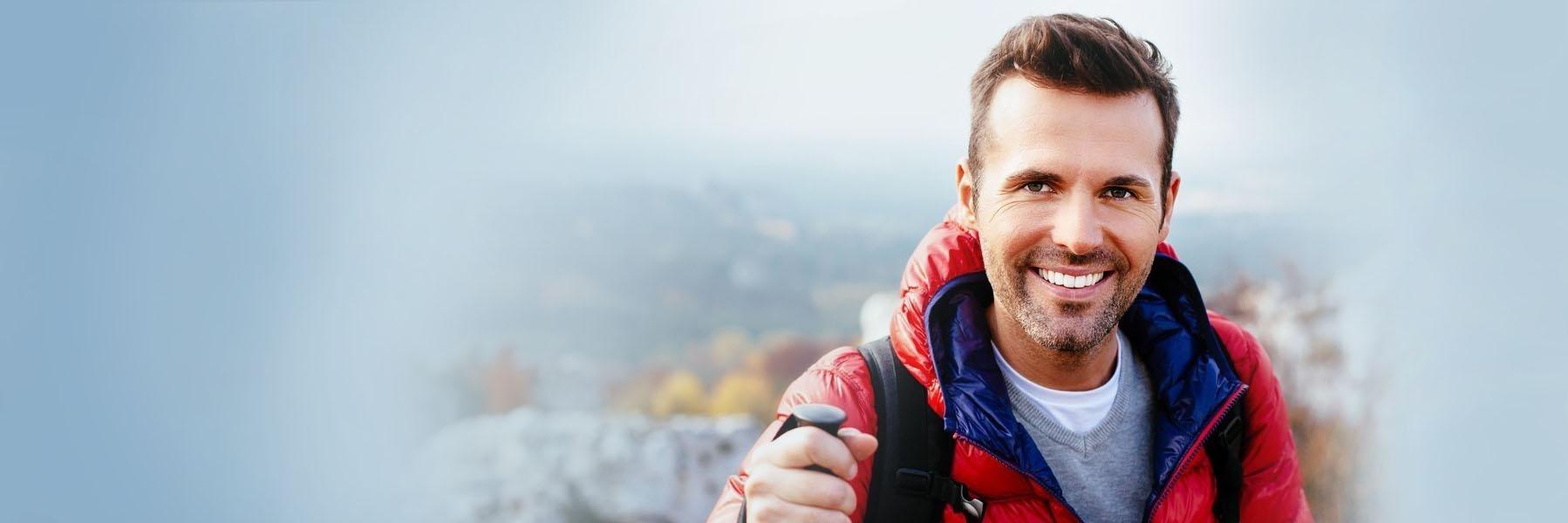 Man wearing outdoor gear smiling l Tooth Colored Fillings Royal Oak MI